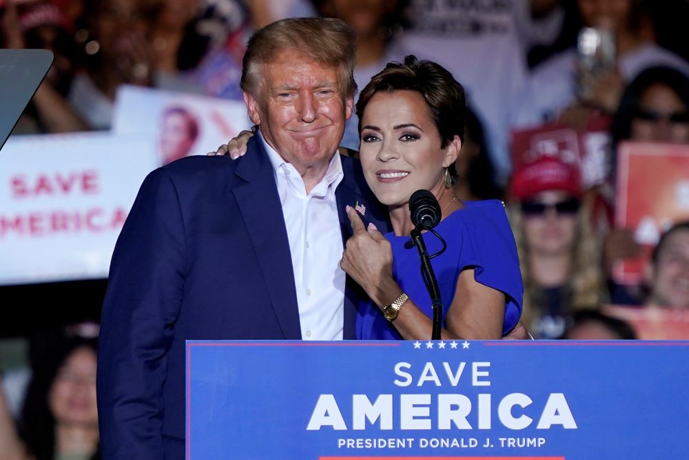 Arizona Republican gubernatorial candidate Kari Lake, right, speaks as former President Donald Trump listens during a rally, Oct. 9, 2022, in Mesa, Ariz.